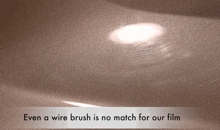 Close-up of scratched car paint self-healing under light after being scraped with a wire brush, showcasing the durability of the paint protection film.
