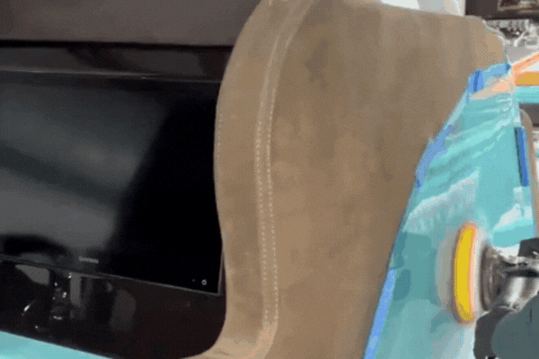 A boat in Osage Beach undergoing Marine Coating Maintenance, with a polisher working along a masked-off section near suede-style upholstery and a built-in screen.